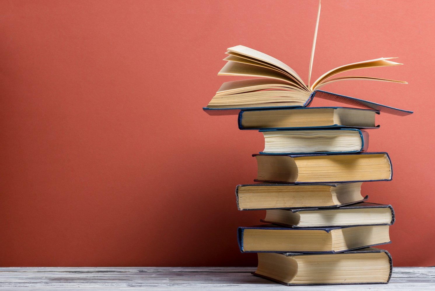 Open book, hardback books on wooden table. Back to school. Copy space